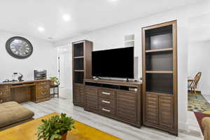 Living room featuring recessed lighting, light wood-type flooring, and baseboards