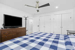 Unfurnished bedroom with ceiling fan, recessed lighting, and multiple closets