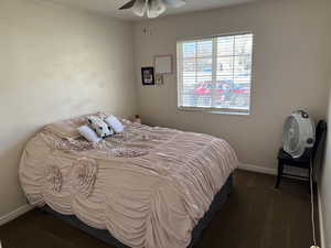 Bedroom featuring a ceiling fan, carpet floors, and baseboards