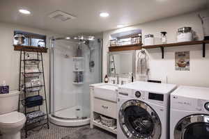 Bathroom featuring visible vents, washer and dryer, tile patterned flooring, recessed lighting, and a stall shower