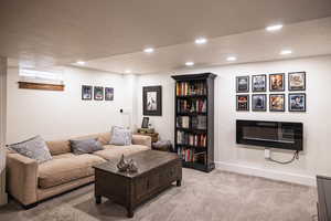 Living area with recessed lighting, carpet, a textured ceiling, and baseboards