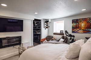 Bedroom with recessed lighting, carpet, and a textured ceiling