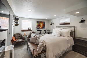 Bedroom with recessed lighting, carpet flooring, visible vents, and a textured ceiling