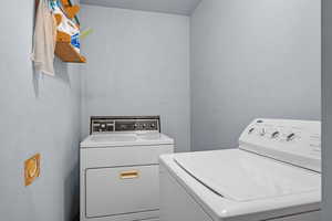 Laundry area featuring washer and clothes dryer and laundry area