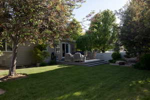 View of yard with a wooden deck
