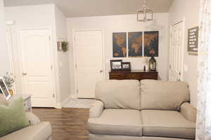 Living area with dark wood-style floors and baseboards