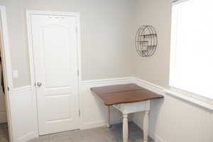 Unfurnished office featuring wainscoting and carpet flooring