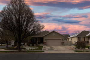 Single story home featuring a gate, fence, a garage, concrete driveway, and stucco siding