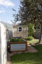 View of shed featuring a mountain view and a vegetable garden