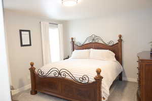 Bedroom with baseboards and carpet flooring