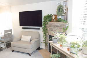 Sitting room featuring a stone fireplace