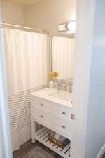 Bathroom featuring vanity and wood finished floors