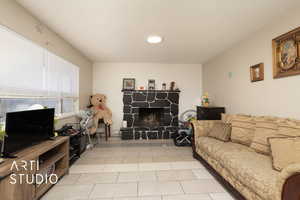 Living area with a fireplace and light tile patterned floors