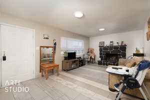 Living area with light tile patterned flooring and a fireplace