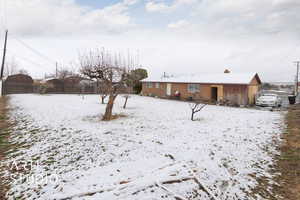 View of yard covered in snow