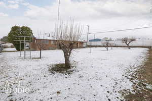 Snowy yard featuring fence