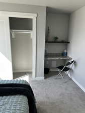 bedroom 3 with custom built in desk and shelf
