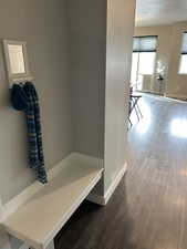 Mudroom featuring baseboards and wood finished floors