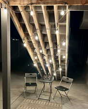 Back yard at night sitting area under stairs
