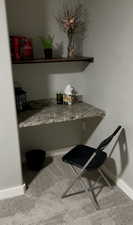 Bed Room 5 details featuring built in desk and shelf, baseboards and carpet floors