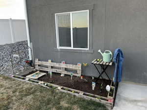 View of property exterior featuring stucco siding and fence