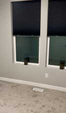 Room details featuring baseboards and carpet floors 2 large windows