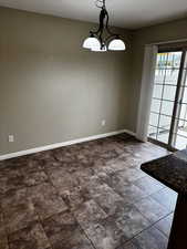 Unfurnished dining area with baseboards