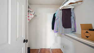 Walk in closet featuring wood finished floors