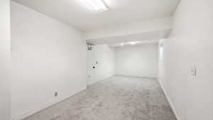 Unfurnished room featuring baseboards and carpet