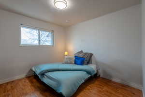 Bedroom with baseboards and wood finished floors