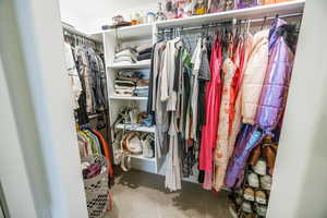 Walk in closet with carpet floors