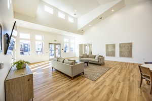 Living area with light wood-style flooring, baseboards, and visible vents