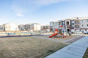 Community playground featuring a residential view and fence