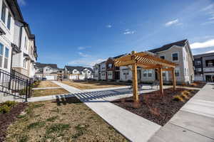 View of home's community featuring a pergola, a residential view, and fence