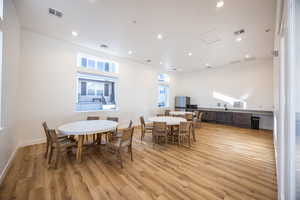 Dining area featuring light wood finished floors, visible vents, and recessed lighting