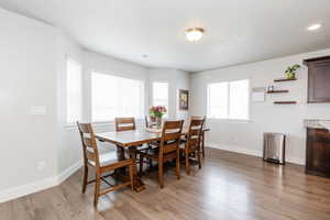 Dining room with baseboards, visible vents, light wood-style floors, and recessed lighting