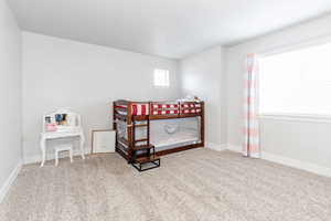 Large Bedroom featuring carpet and baseboards