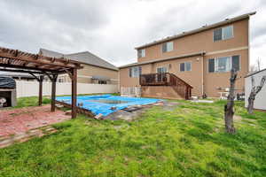 View of swimming pool featuring fence, a patio, a fenced in pool, a pergola, and a yard