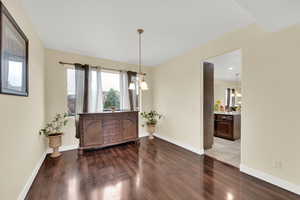 Interior space featuring baseboards and hardwood / wood-style flooring