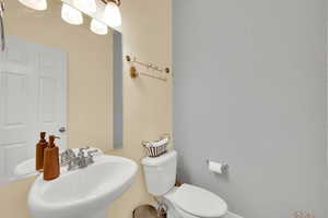 Half bathroom with toilet and a sink