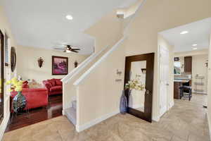 Stairway featuring baseboards, recessed lighting, and a ceiling fan