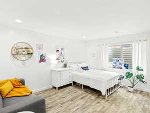 Bedroom with baseboards, light wood-style floors, and recessed lighting