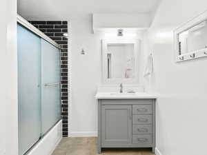 Bathroom featuring tile patterned floors, vanity, and baseboards