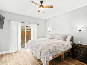 Bedroom with access to outside, a ceiling fan, and wood finished floors