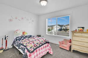 Carpeted bedroom featuring baseboards and visible vents