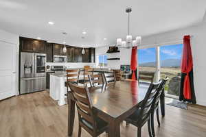 Dining space featuring recessed lighting, light wood-style floors, a mountain view, and a chandelier