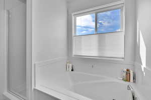 Bathroom featuring a shower and a garden tub