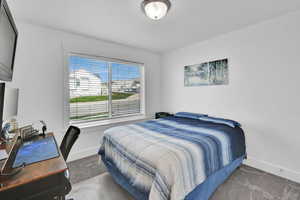 Carpeted bedroom featuring baseboards