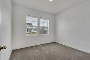 Unfurnished room with baseboards, carpet flooring, and visible vents