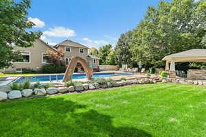 View of pool with fence, a patio, a fenced in pool, a gazebo, and a lawn